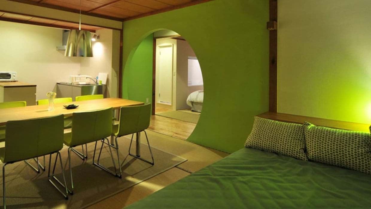 Open-plan dining area with seating for 6 and views into the bedroom