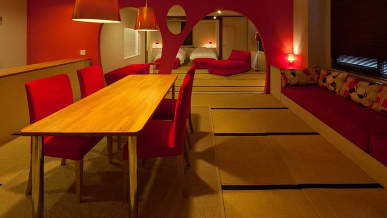 Dining area for 6 with traditional tatami flooring and adjacent sleeping nook