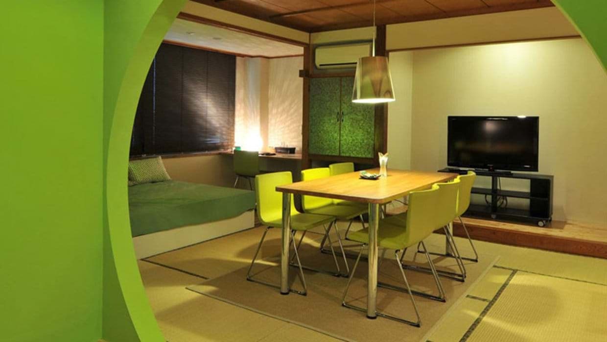 Open-plan dining area with tatami flooring and adjacent daybed