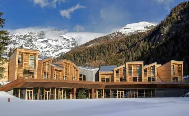Ski-in/ski-out chalet exterior with wood cladding and mountain views