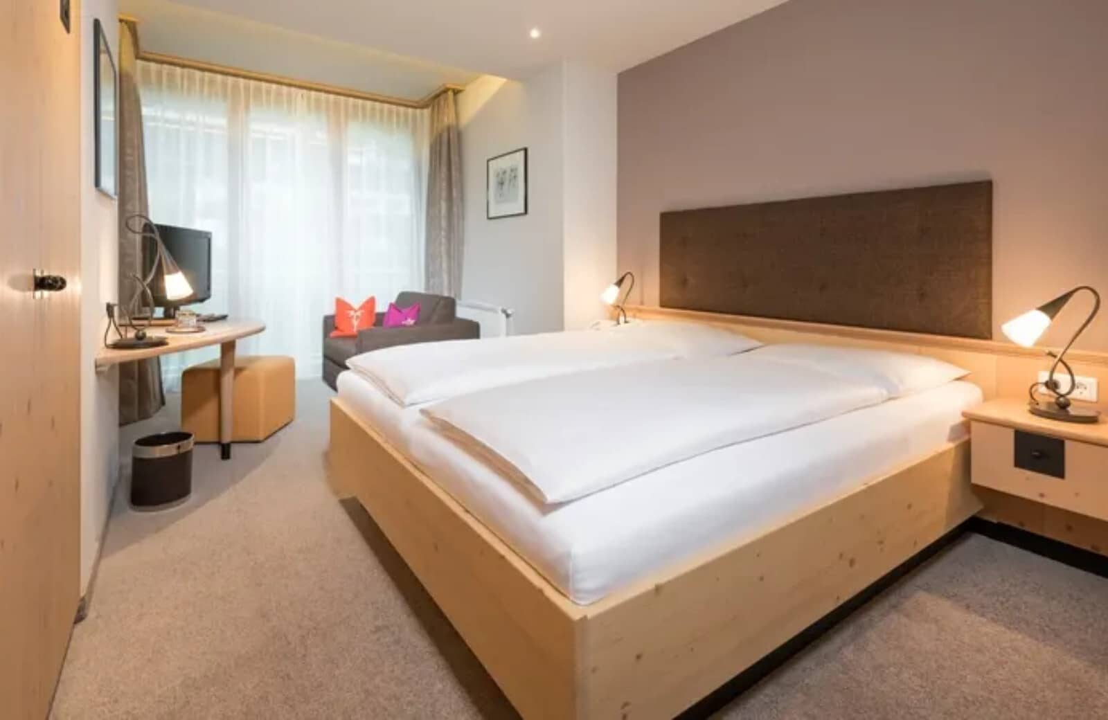 Guest bedroom with king bed, workstation, and armchair seating