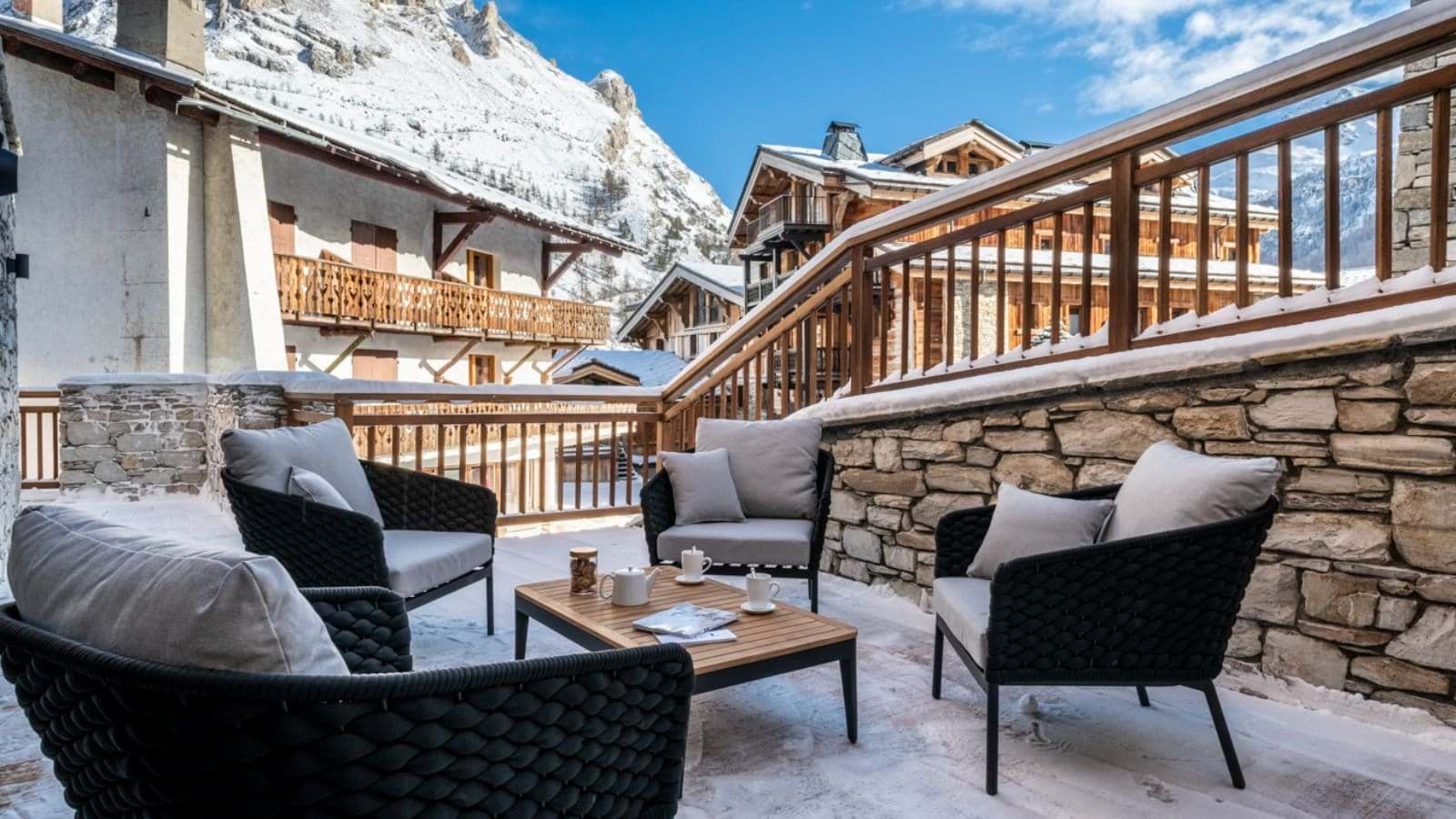Private sun terrace with mountain views and lounge seating for four