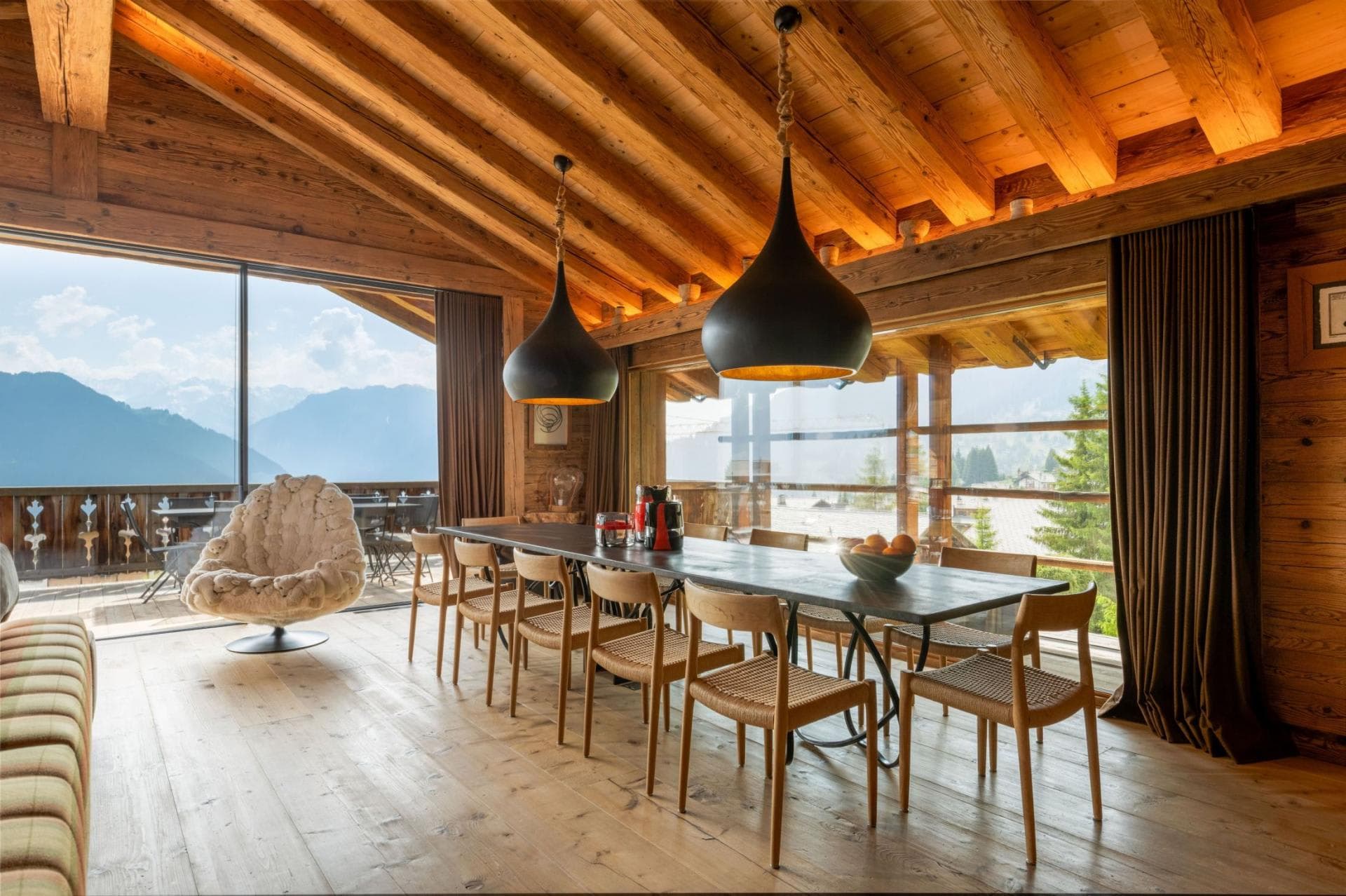Dining area seats 12; floor-to-ceiling windows with mountain views
