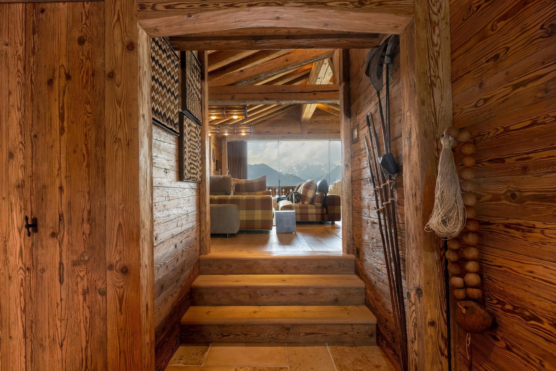 Entryway stairs leading to living area with vaulted ceilings and mountain views