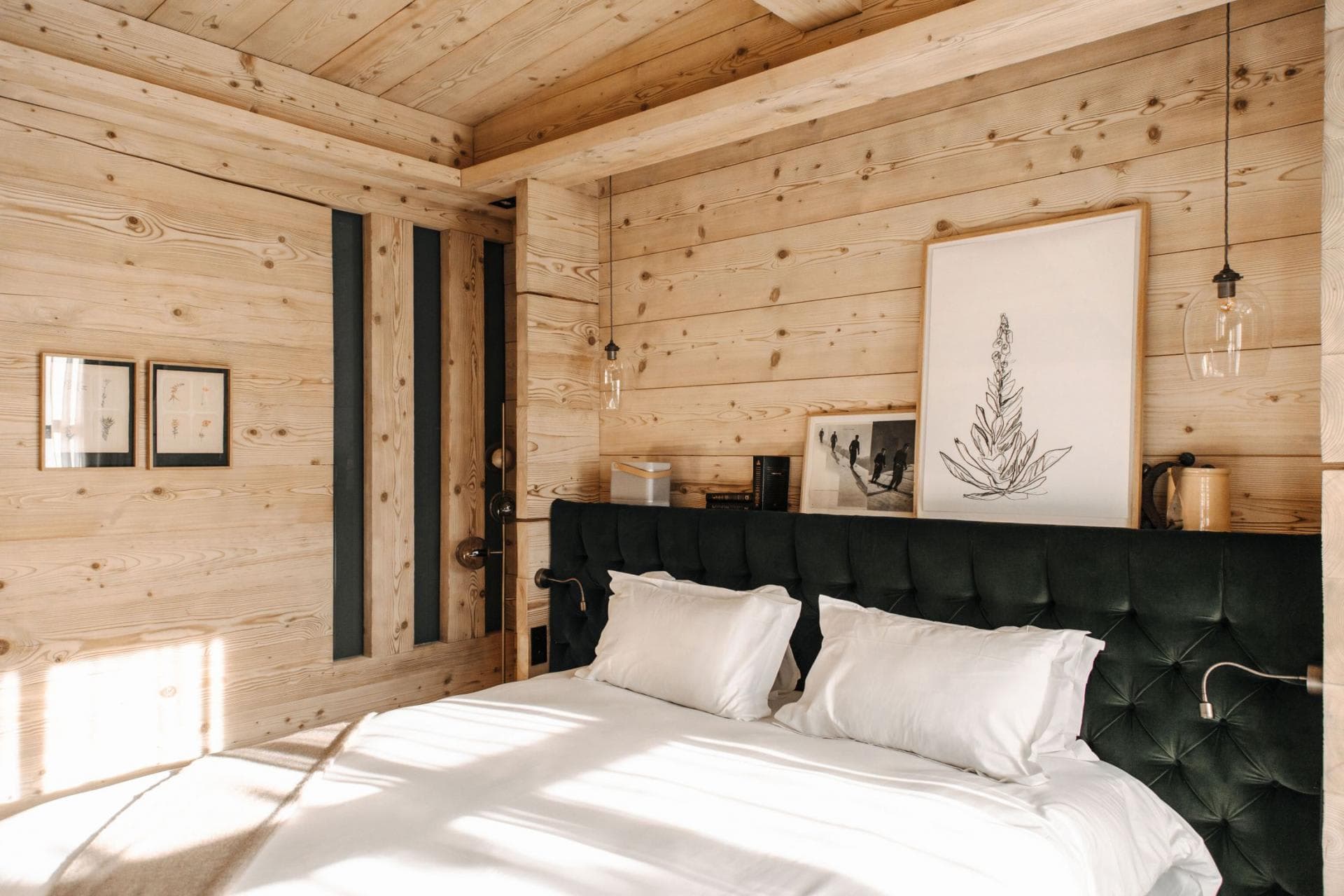Bedroom with king bed, pine paneling, and integrated reading lights