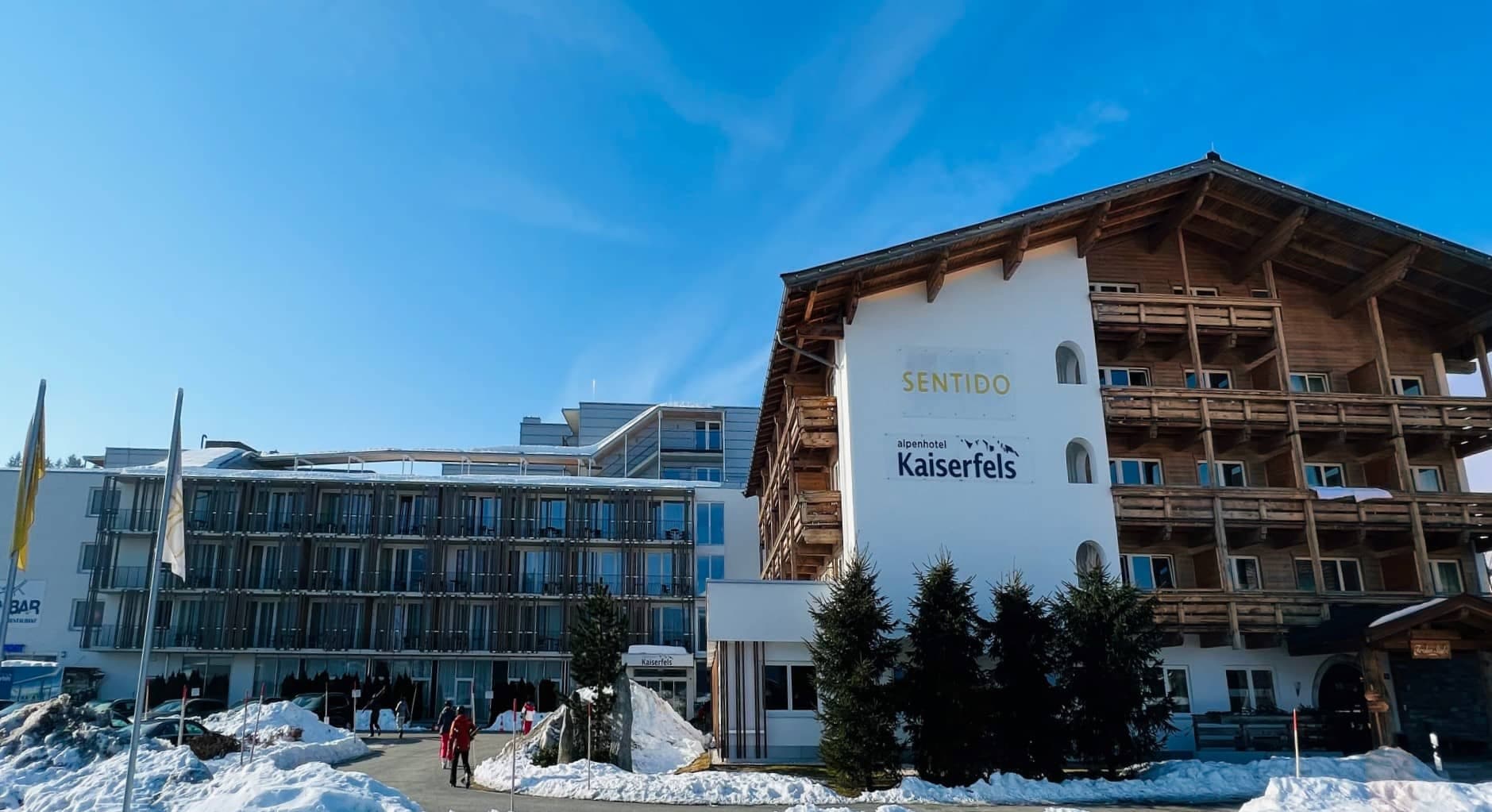 Ski-in/ski-out hotel exterior with wooden balconies and direct slope access
