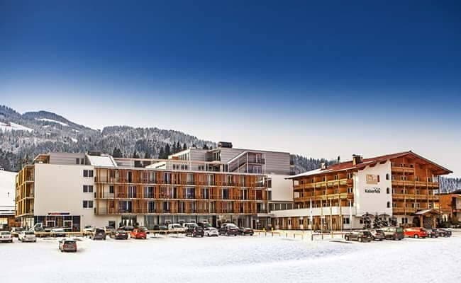 Ski-in/ski-out hotel exterior with mountain views and on-site parking