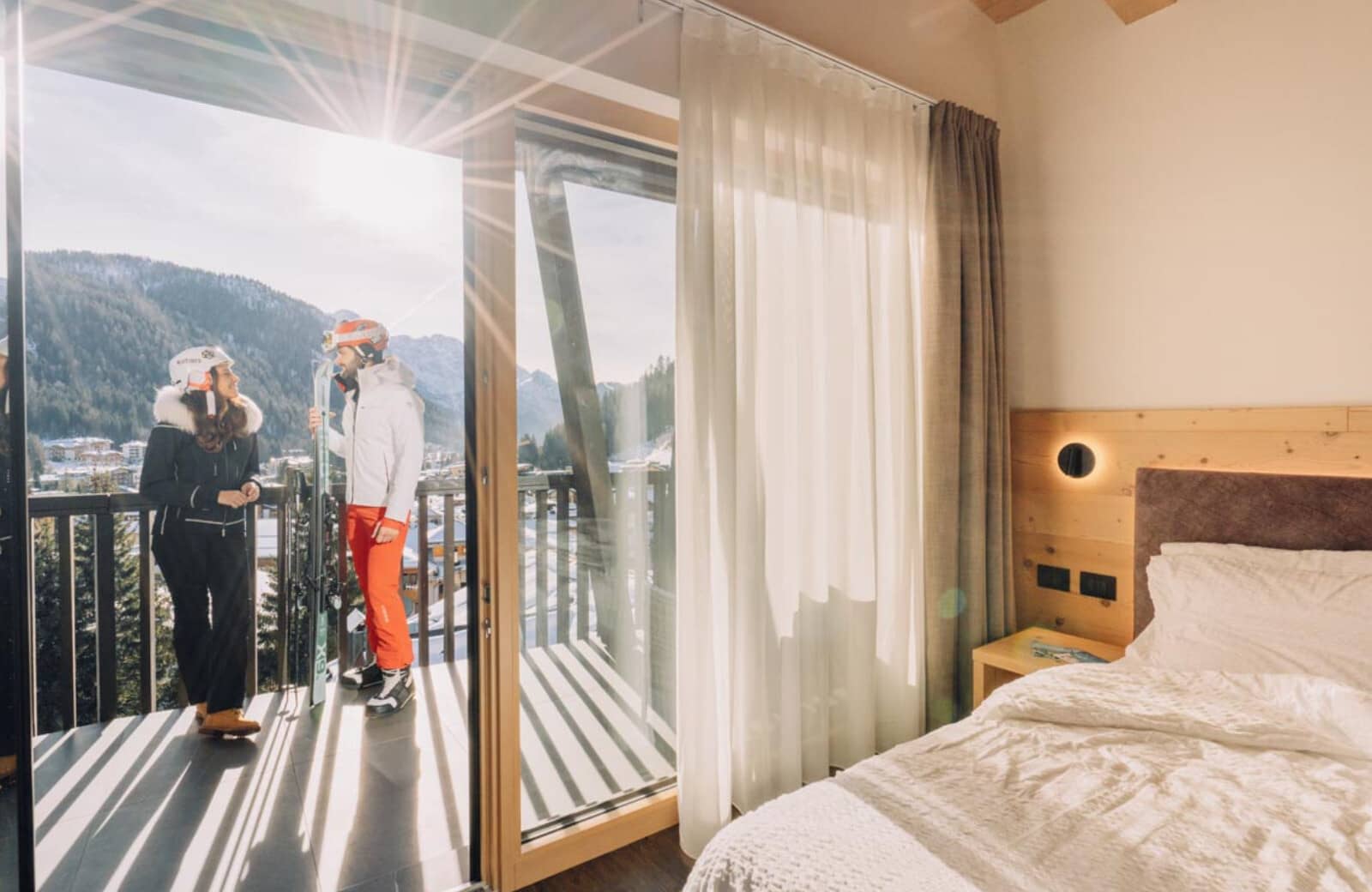 Guest bedroom with private balcony access and mountain views