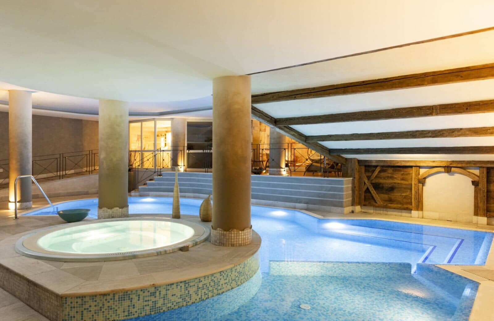 Indoor pool and circular hot tub with original exposed timber beams