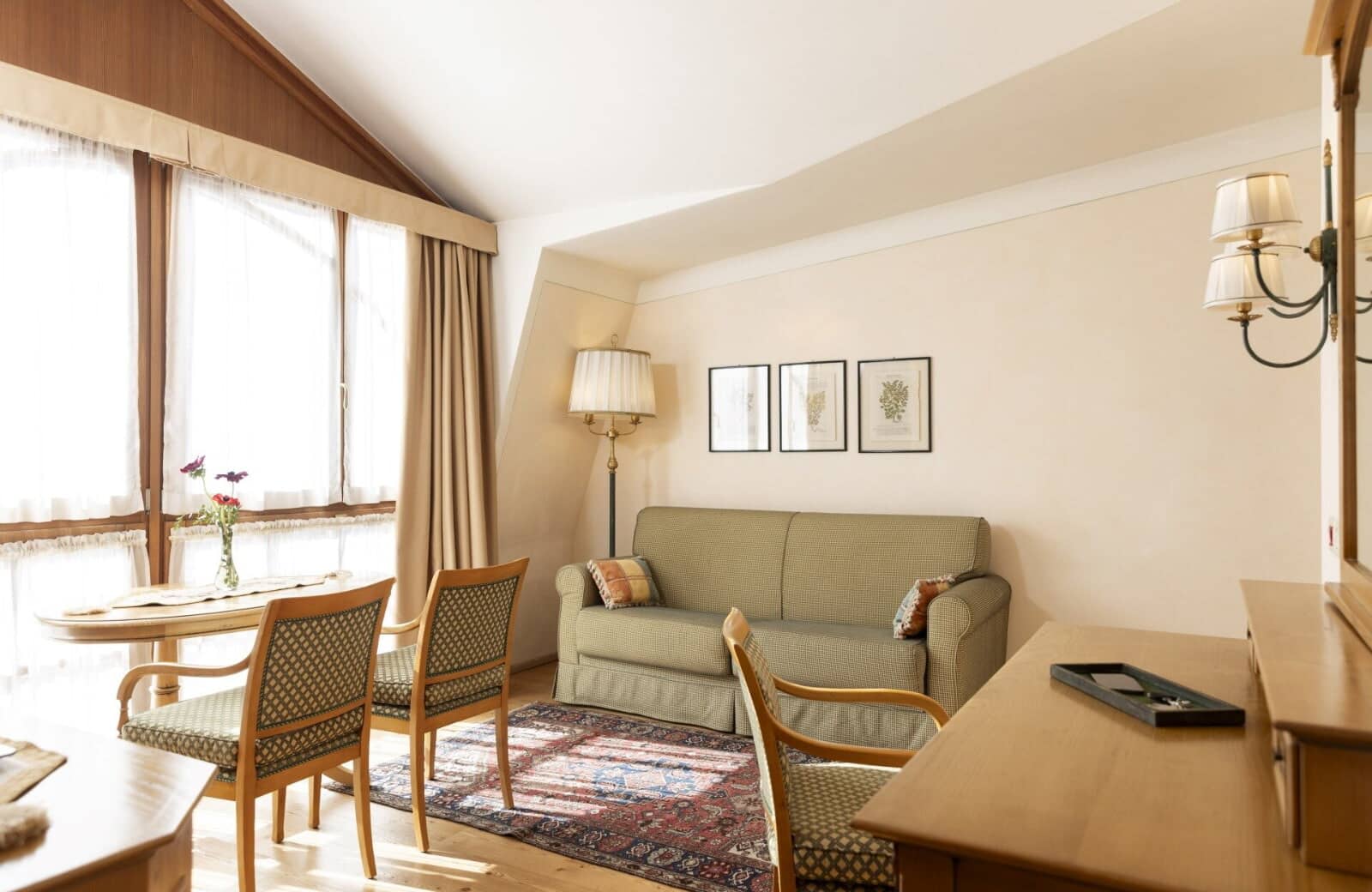 Sitting area with sleeper sofa and workspace under vaulted ceilings