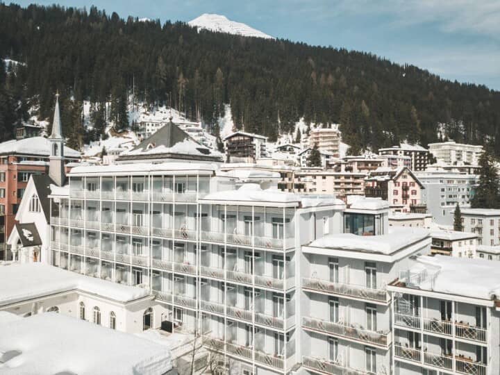Hotel exterior featuring private balconies with mountain and alpine village views