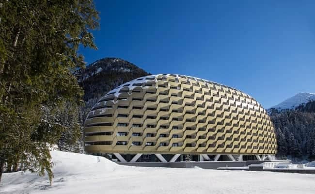 Building exterior featuring private balconies with mountain and forest views