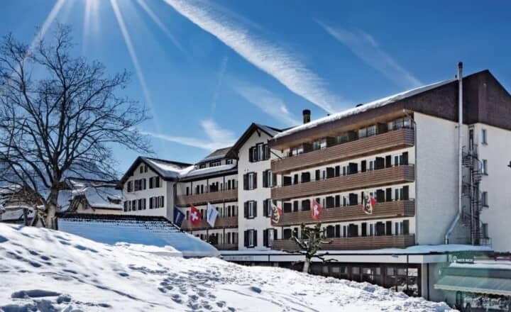 Ski-in/ski-out hotel exterior with private balconies and mountain views