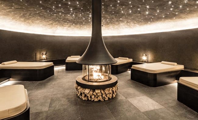 Spa relaxation room with central wood fireplace and fiber optic star ceiling
