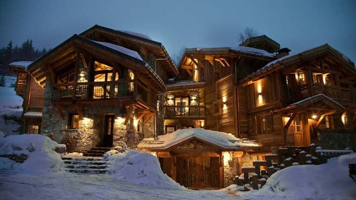Ski-in chalet exterior with heated driveway and multiple private balconies