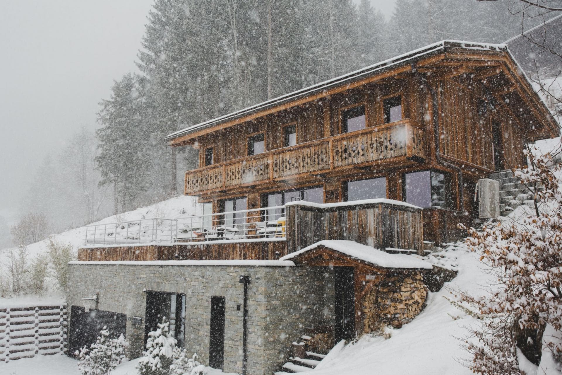 Ski-in chalet with wrap-around balcony and stone-clad lower level