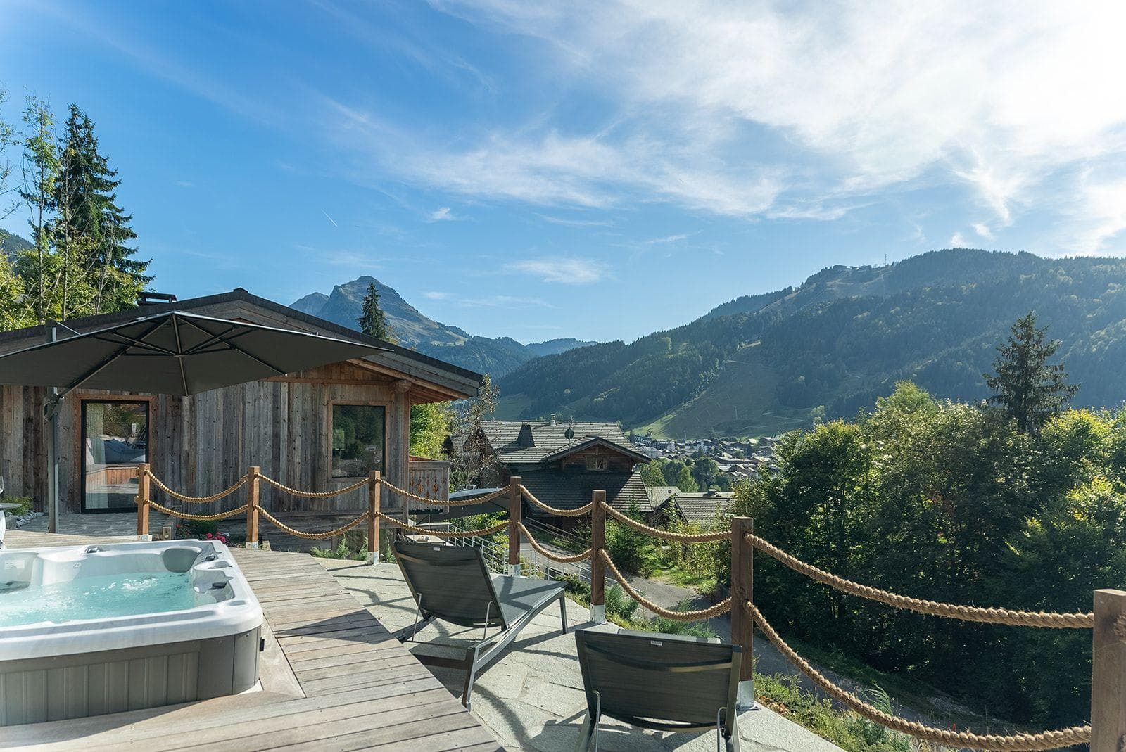 Outdoor hot tub and sun terrace with panoramic mountain views