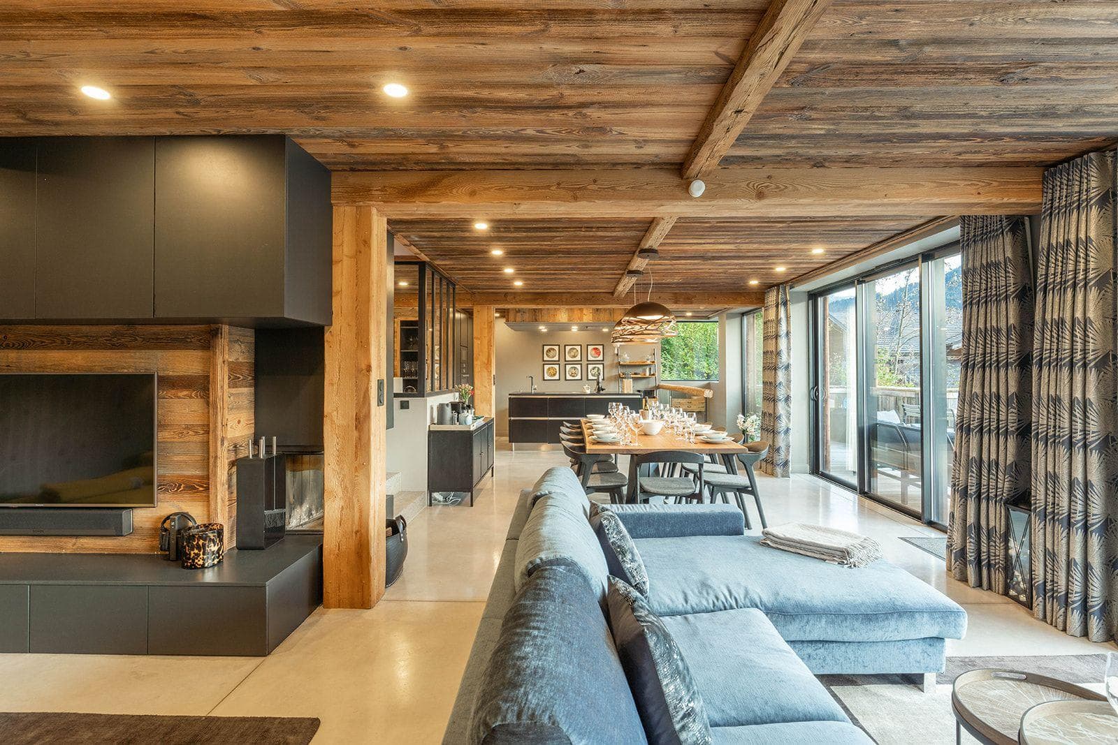 Open-plan living area with wood-burning fireplace and dining table for 10