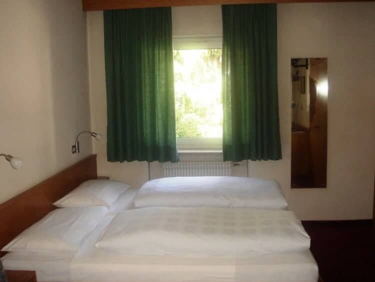 Guest bedroom with two twin beds and bedside reading lamps