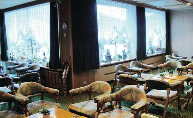 Shared lounge area with armchair seating and large picture windows