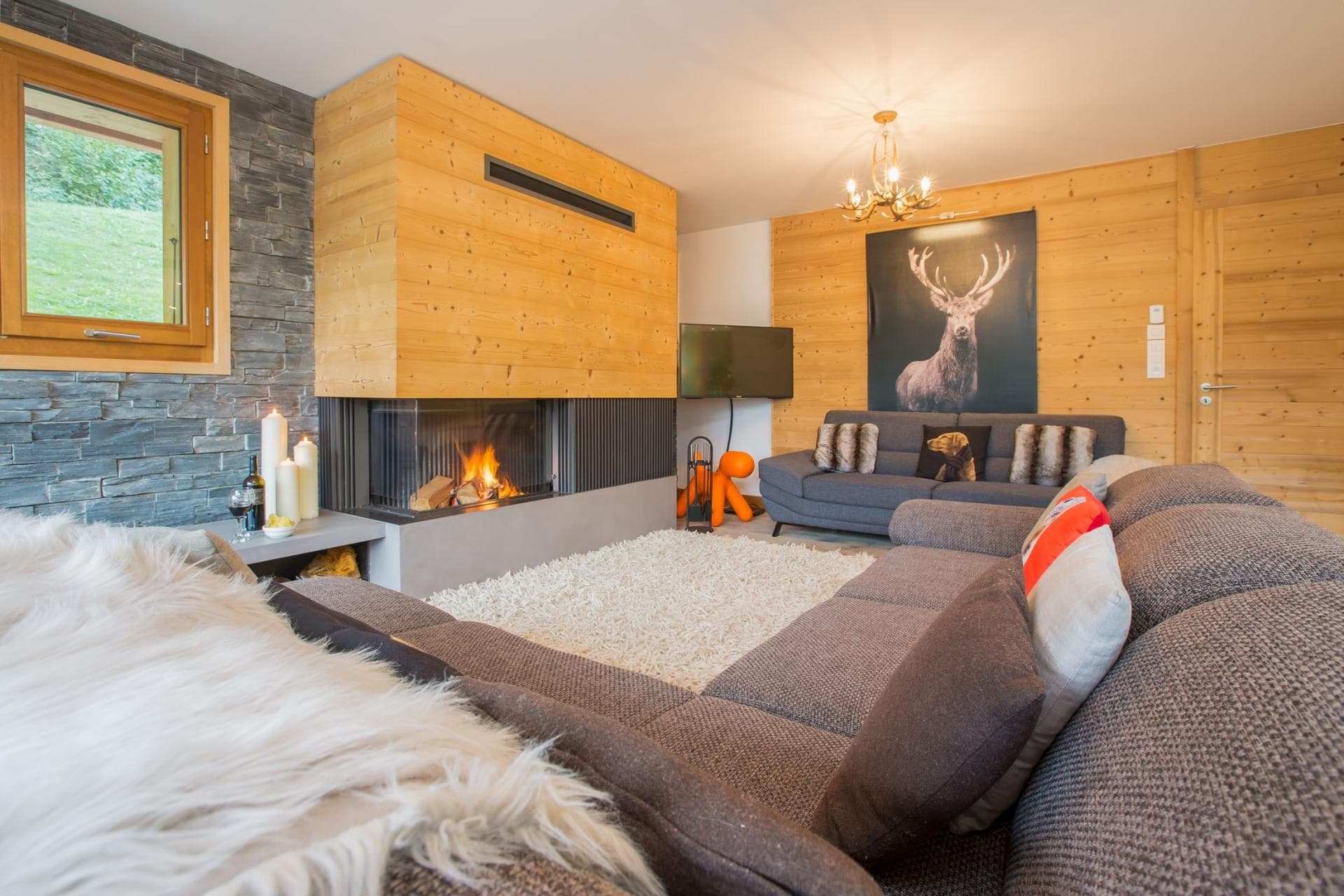 Living area with wood-burning fireplace and sectional seating for 8