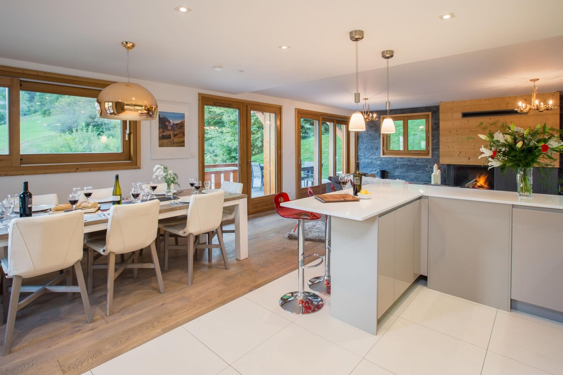 Open-plan dining area seats 8 next to kitchen island and fireplace