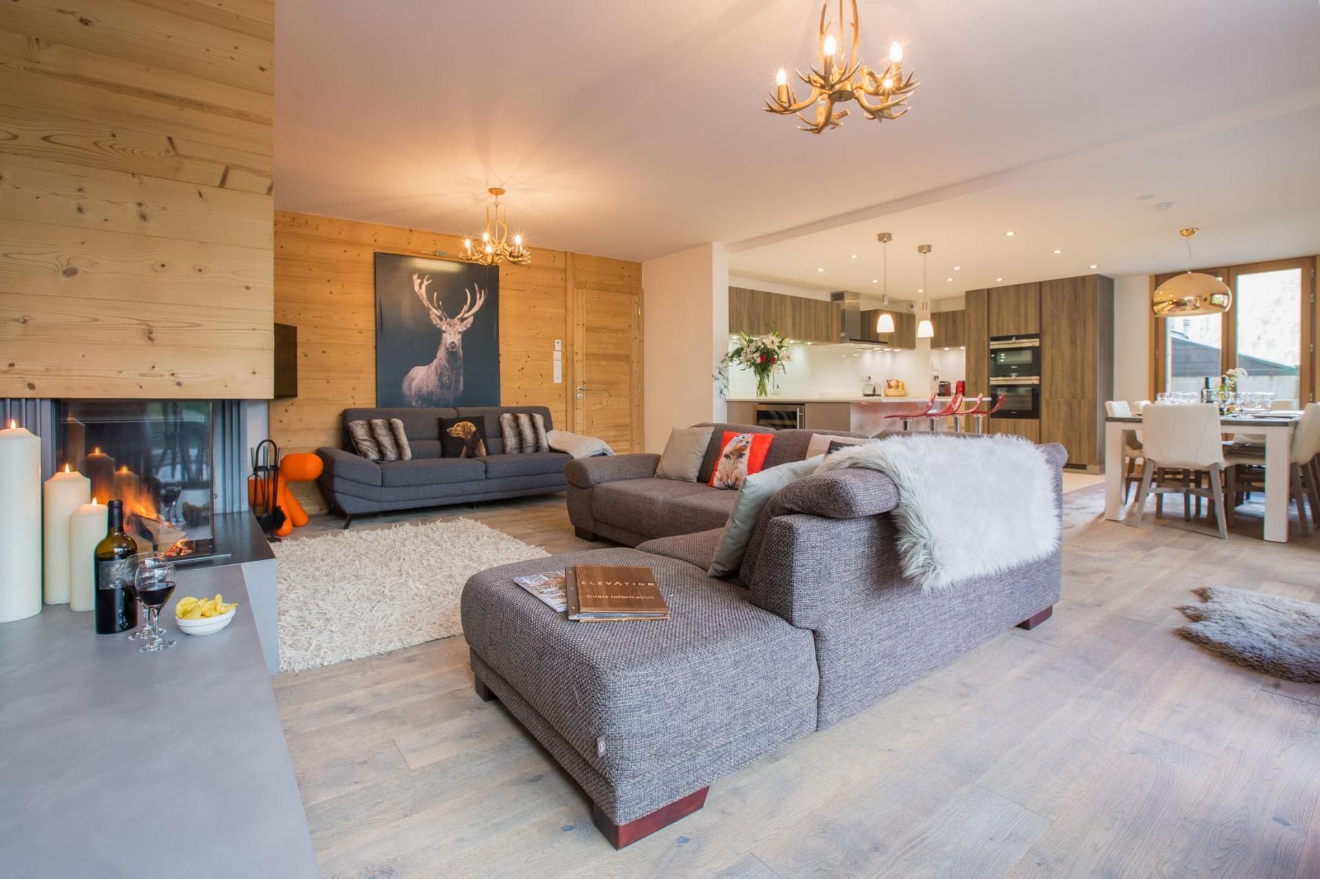 Open-plan living area with wood-burning fireplace and dining seating for 8