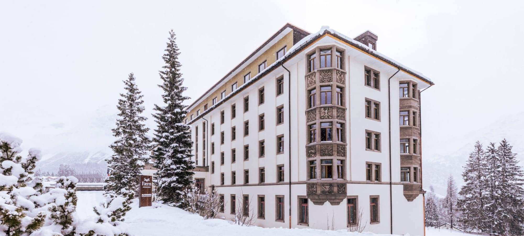 Hotel exterior with original stone carvings and snow-covered grounds