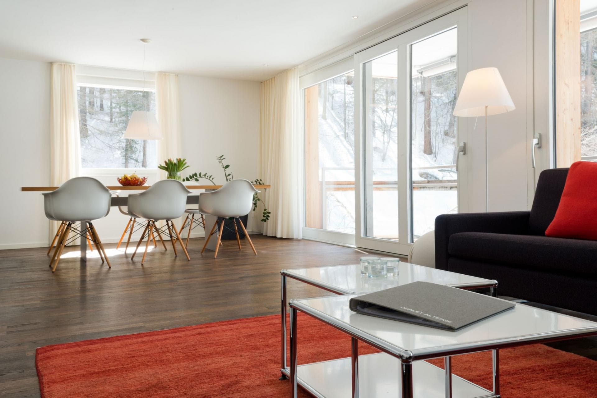 Open-plan living and dining area with sliding glass doors to balcony