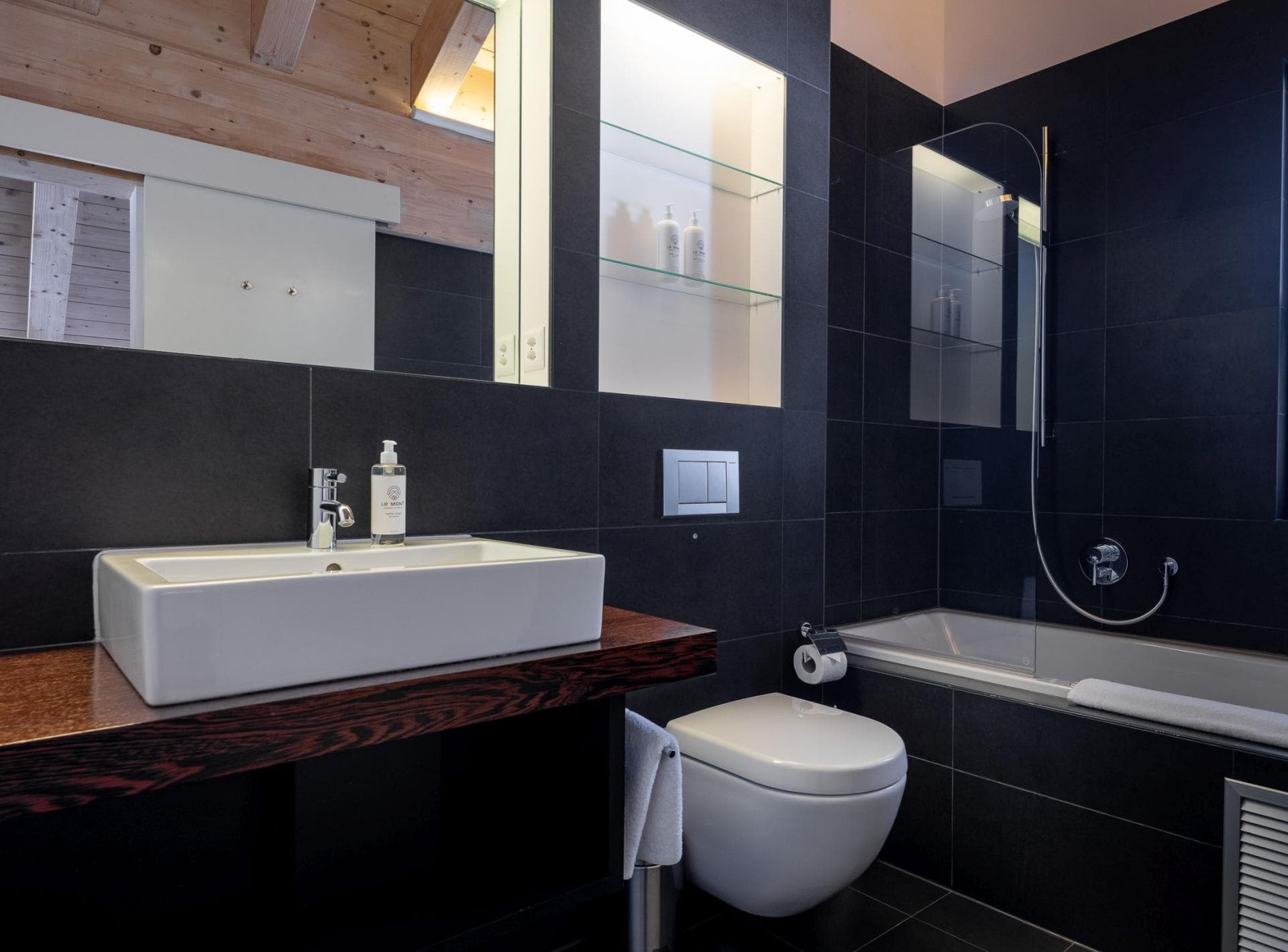 Bathroom with vessel sink and soaking tub with glass splash guard