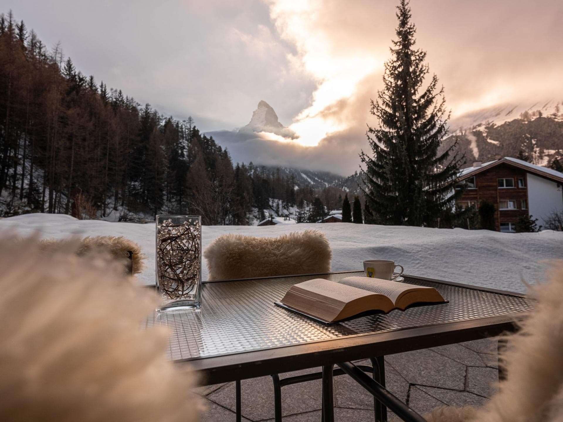 Private stone terrace with Matterhorn views and sheepskin-lined seating