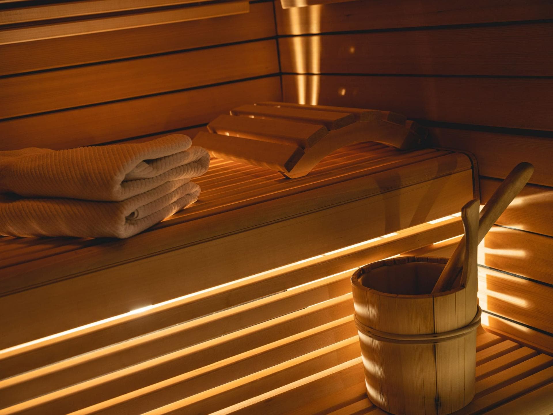 Private cedar sauna with ergonomic headrests and integrated LED lighting