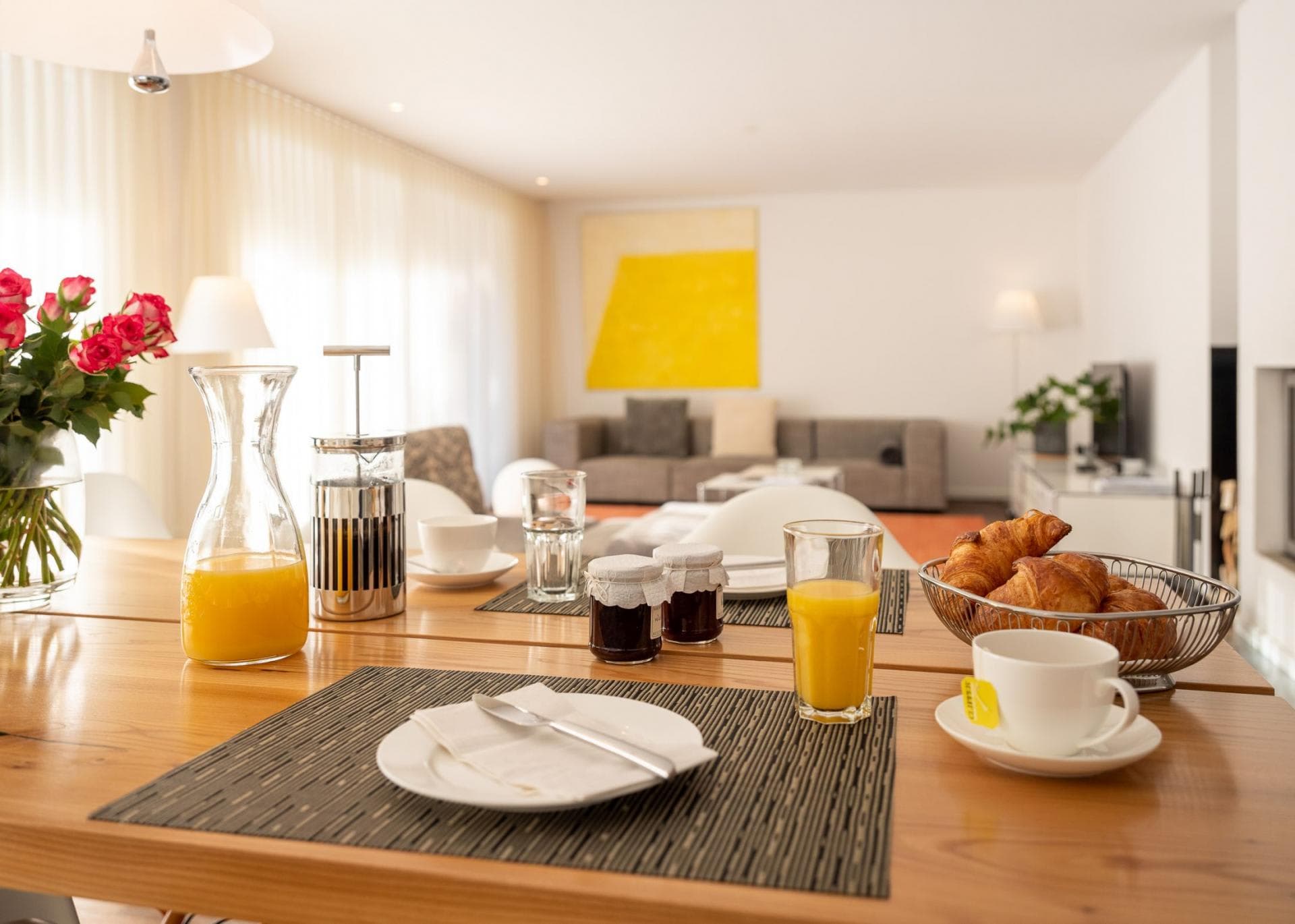 Open-plan dining area overlooking living room and fireplace