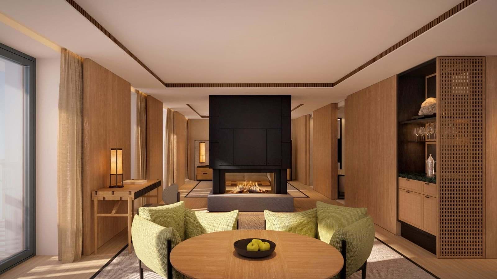 Living area with double-sided gas fireplace, desk, and wet bar