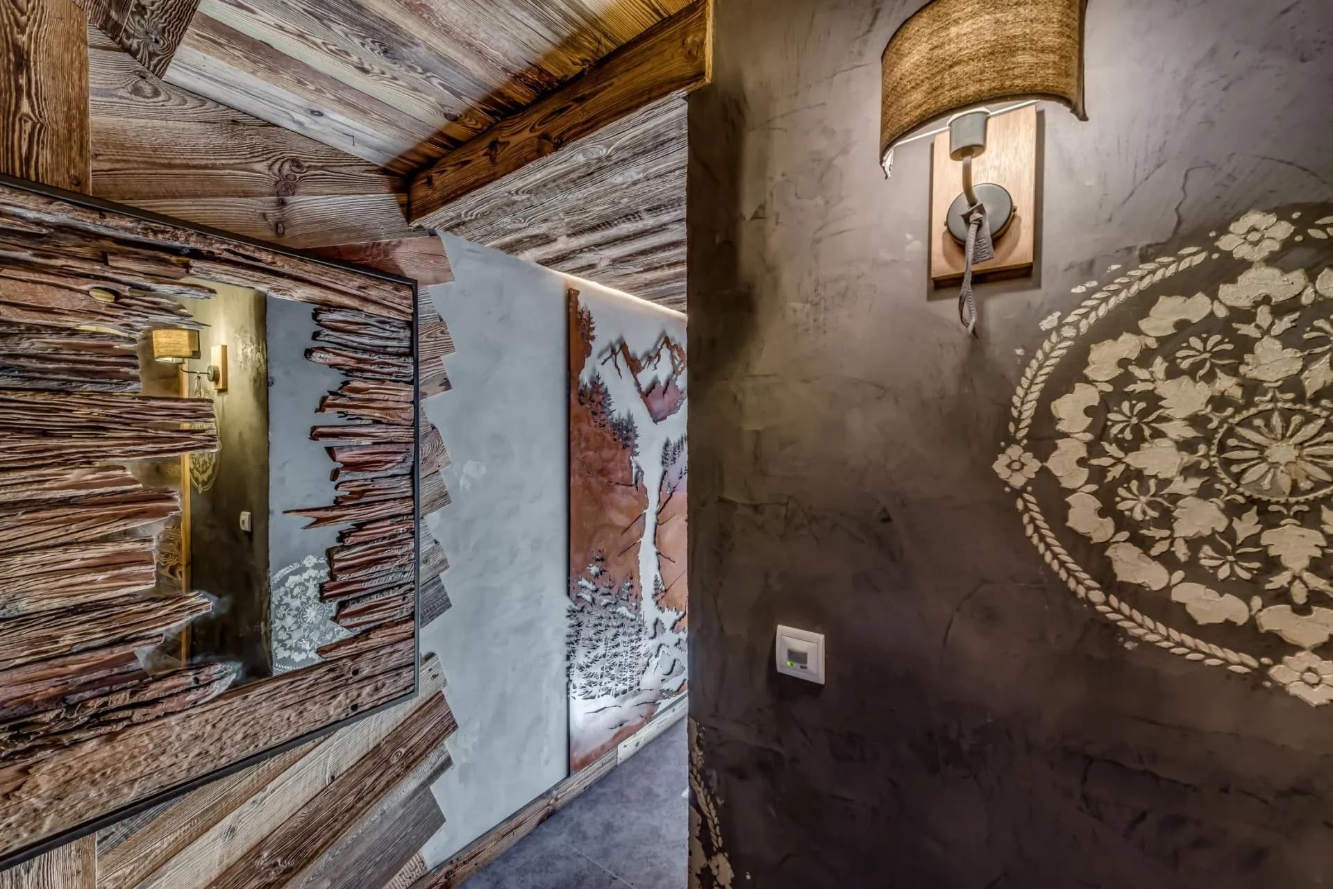 Hallway featuring reclaimed wood paneling and custom mountain wall art