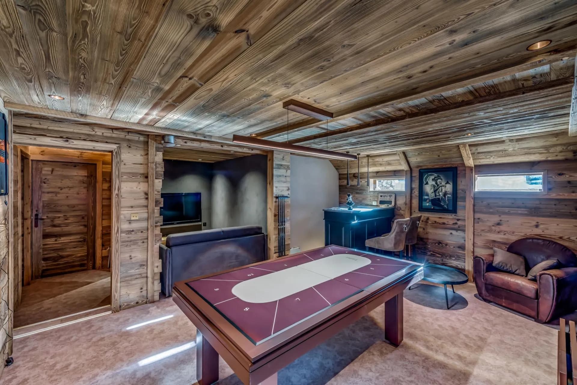 Game room with pool table, wet bar, and adjacent media lounge