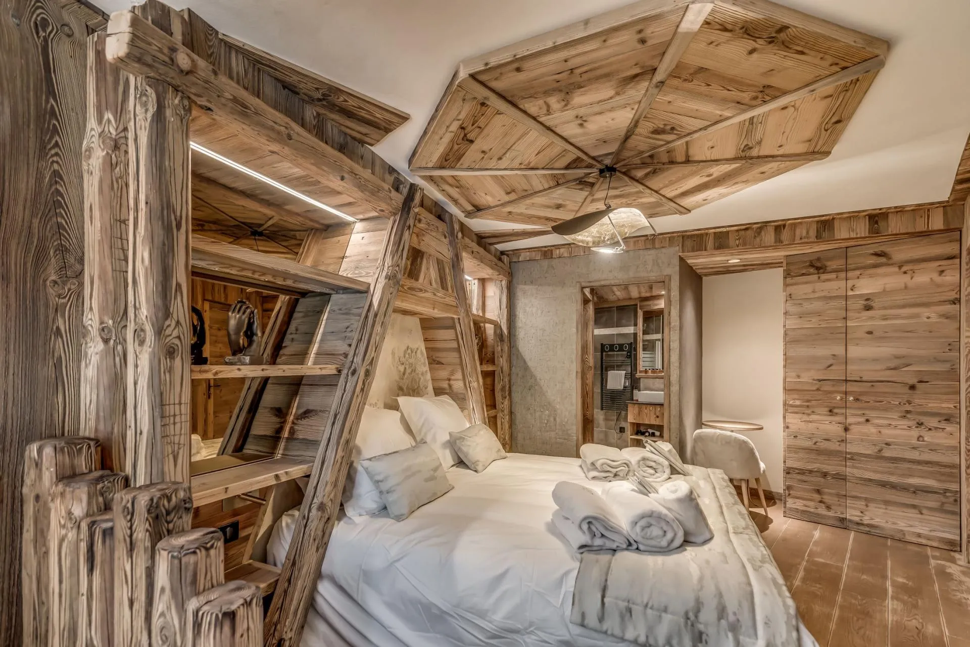 Guest bedroom with reclaimed wood paneling and ensuite bathroom access