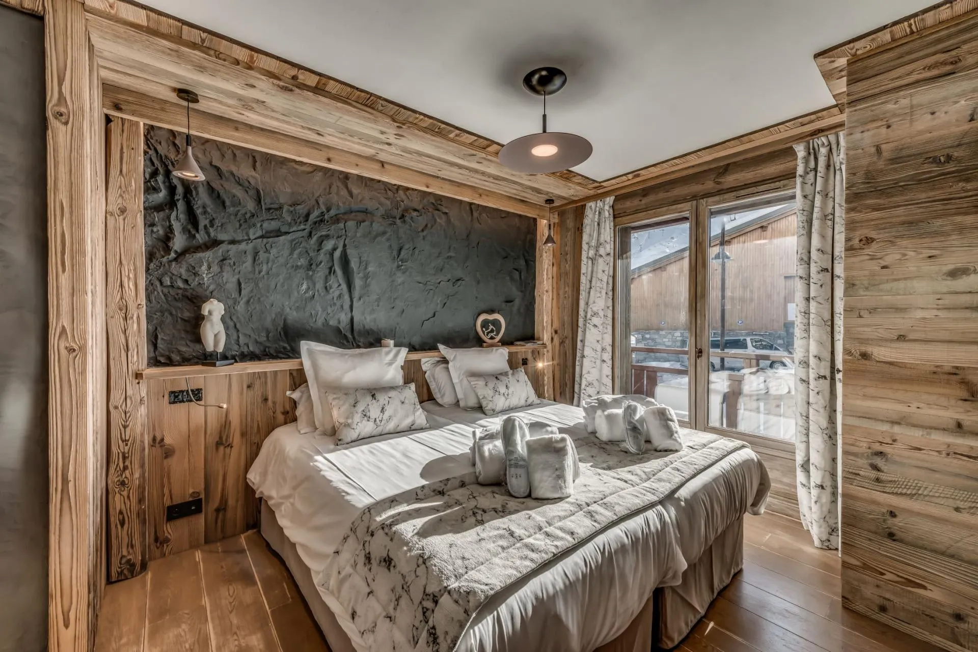 Guest bedroom with king bed and feature rock wall