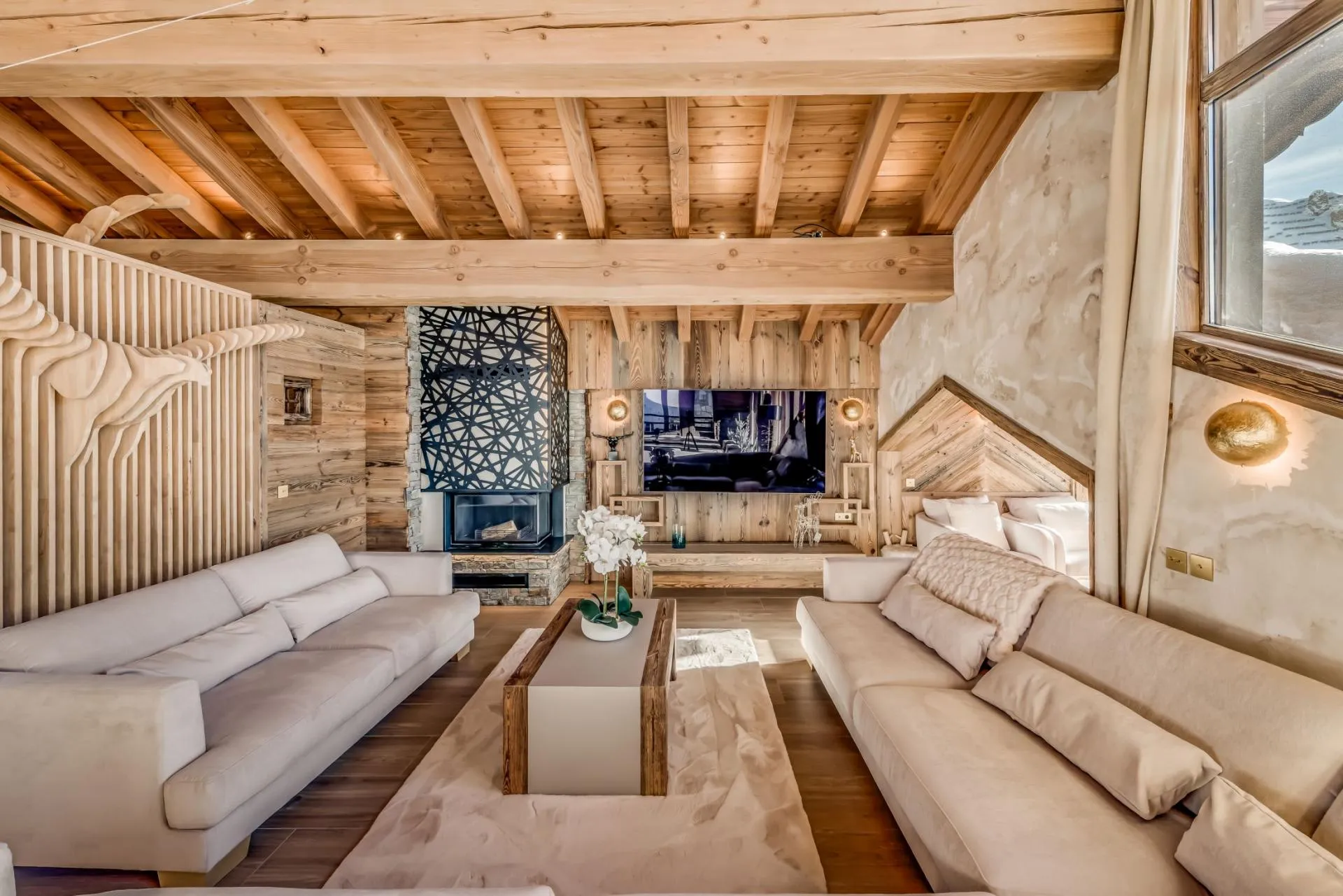 Living area with wood-burning fireplace and smart TV over timber mantle