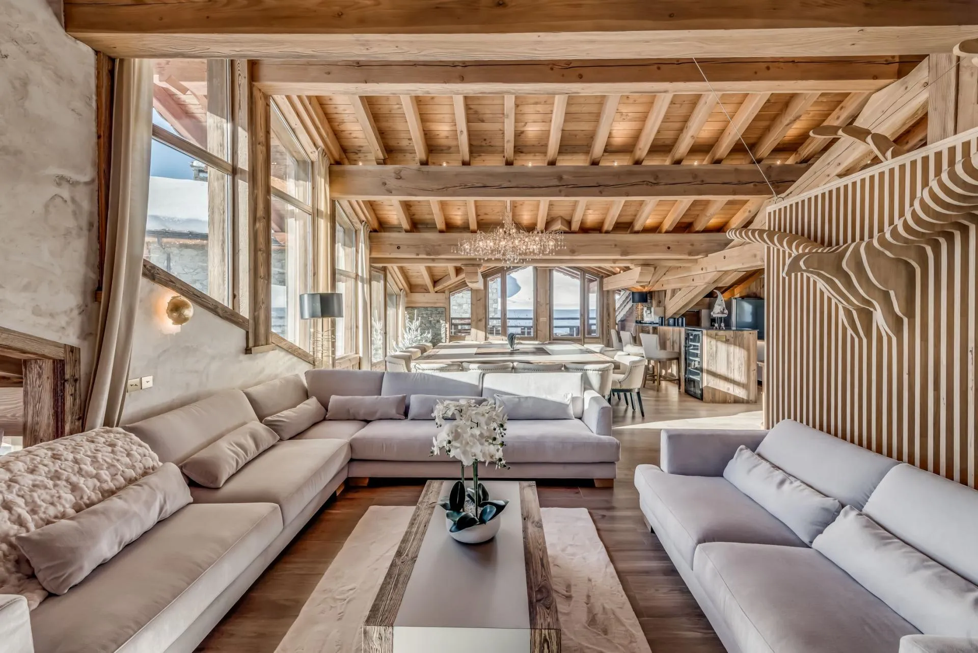 Open-plan living area with vaulted timber ceilings and wine fridge