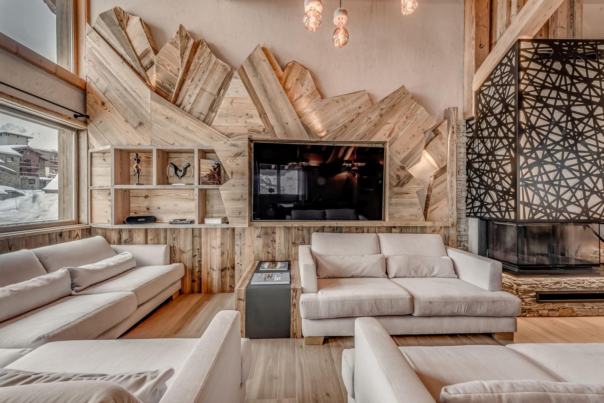 Living area with wood-burning fireplace and mountain-view windows