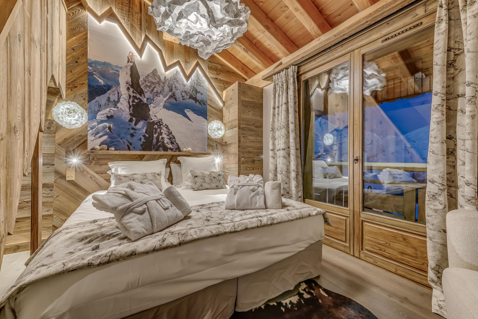 Guest bedroom with queen bed and private balcony access