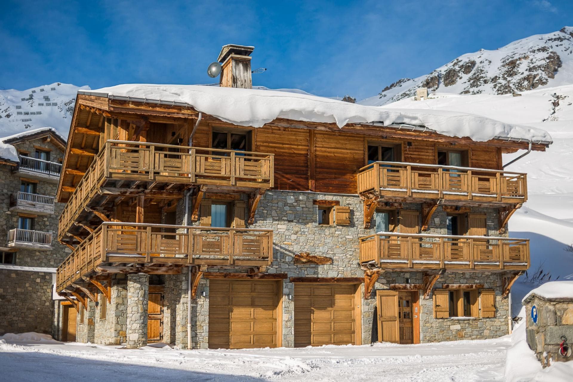 Ski chalet exterior with two-car garage and private balconies