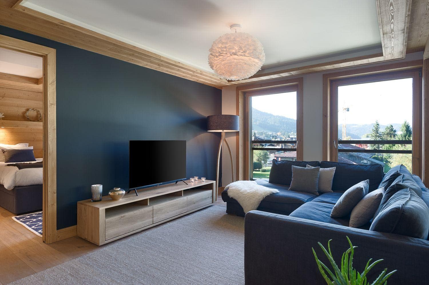 Living area with Smart TV, sectional seating, and village views