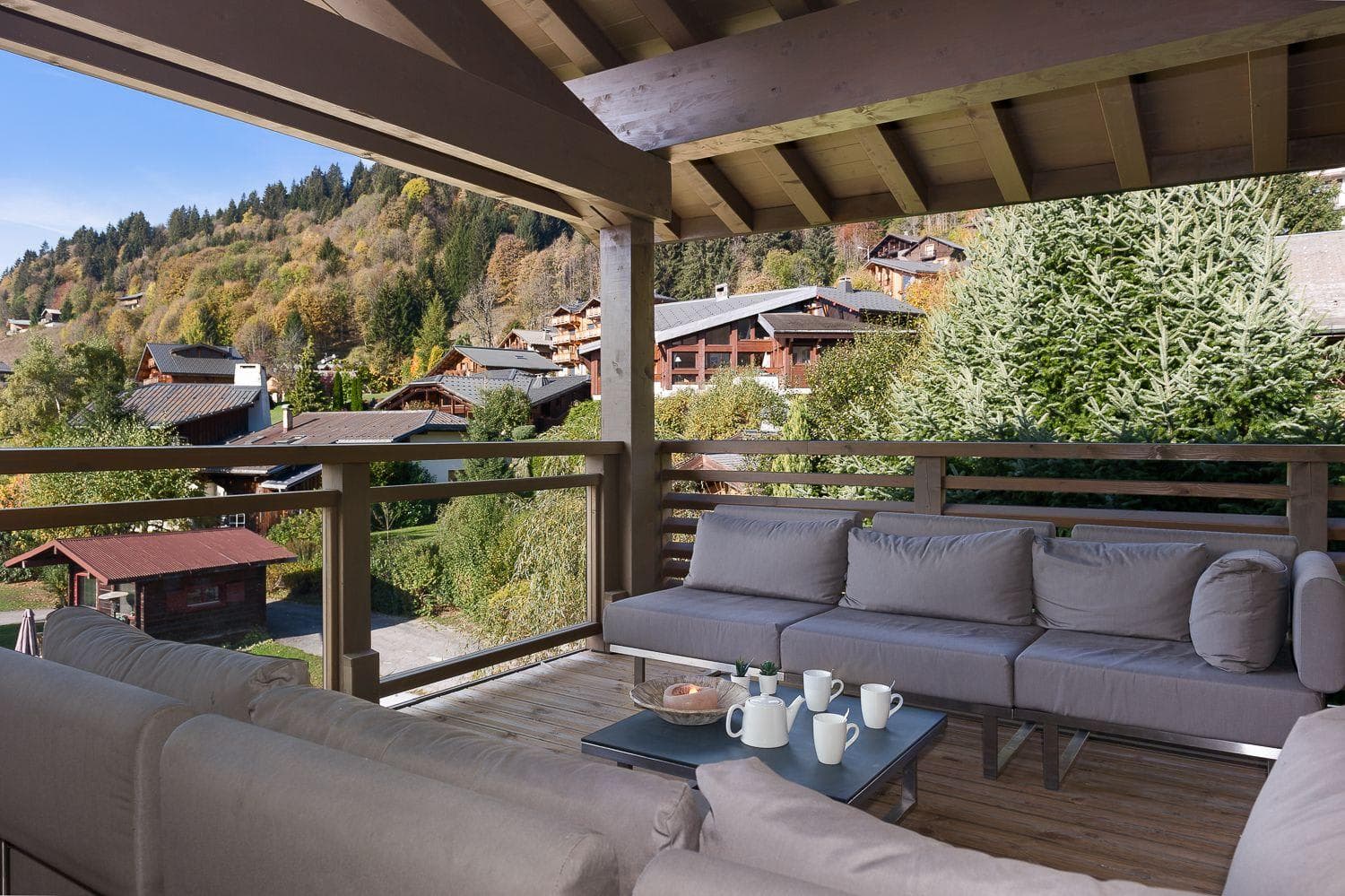 Covered balcony with sectional seating and alpine village views