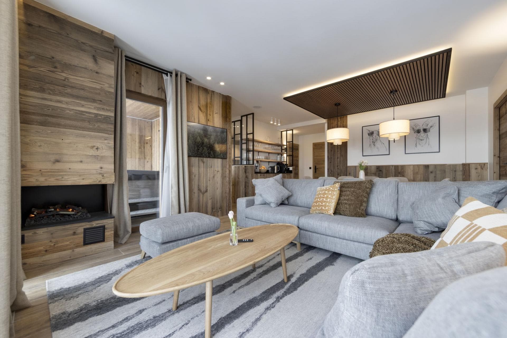 Living area with wood-burning fireplace and direct balcony access