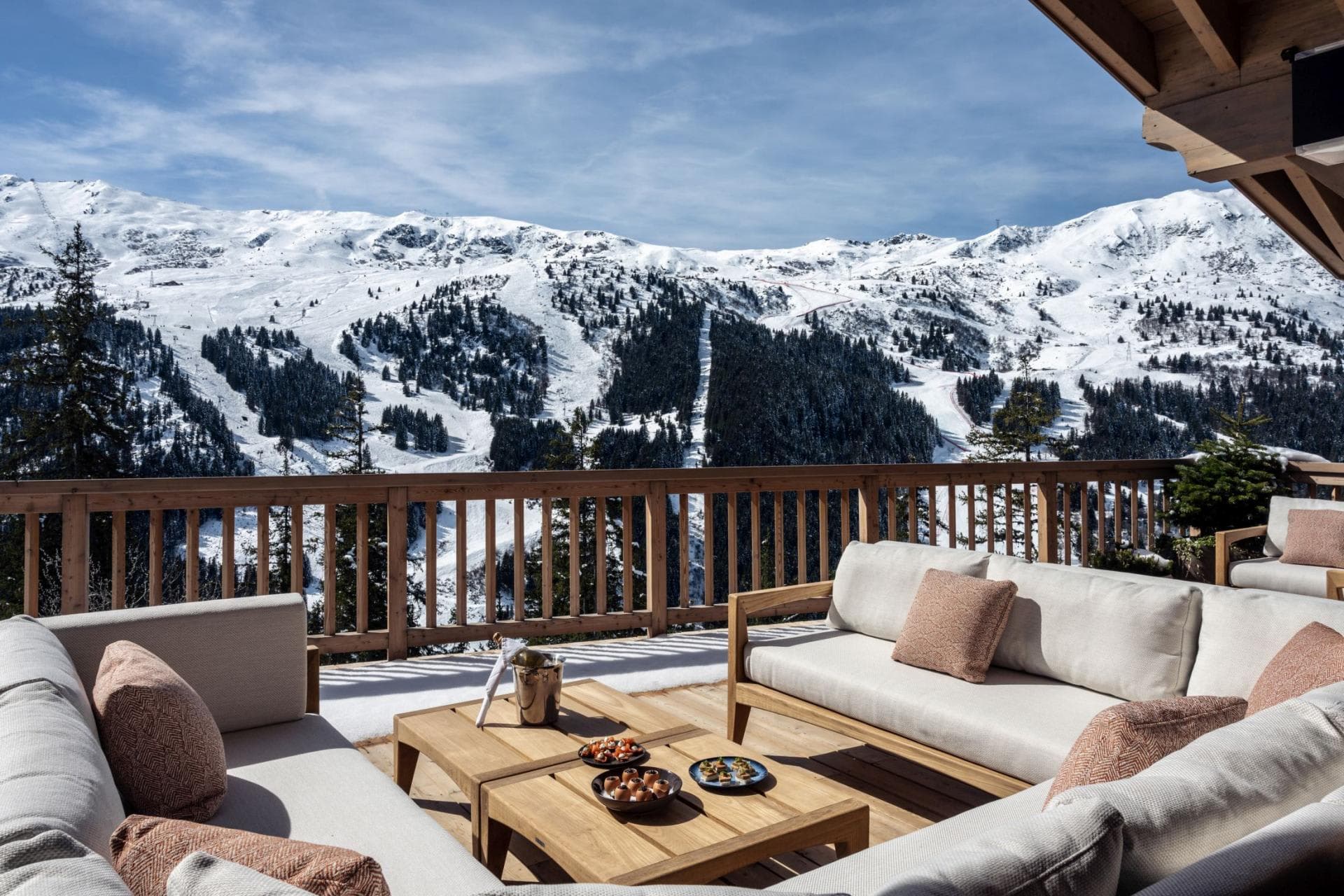 Outdoor terrace with sectional seating and panoramic ski slope views
