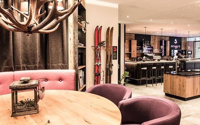 Lobby lounge and cocktail bar with booth seating and antler chandelier