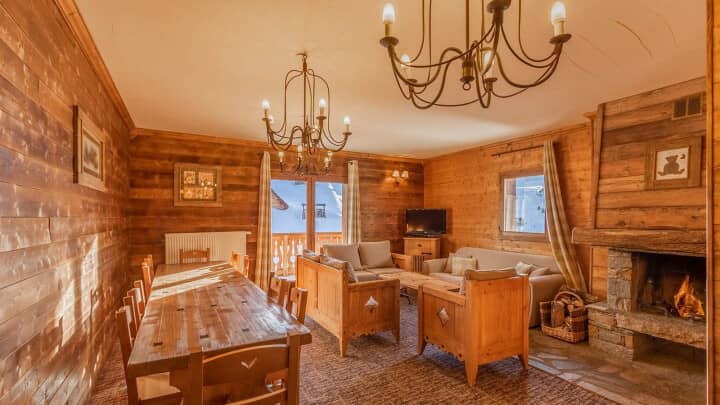 Open living area with wood-burning fireplace and dining table for 10