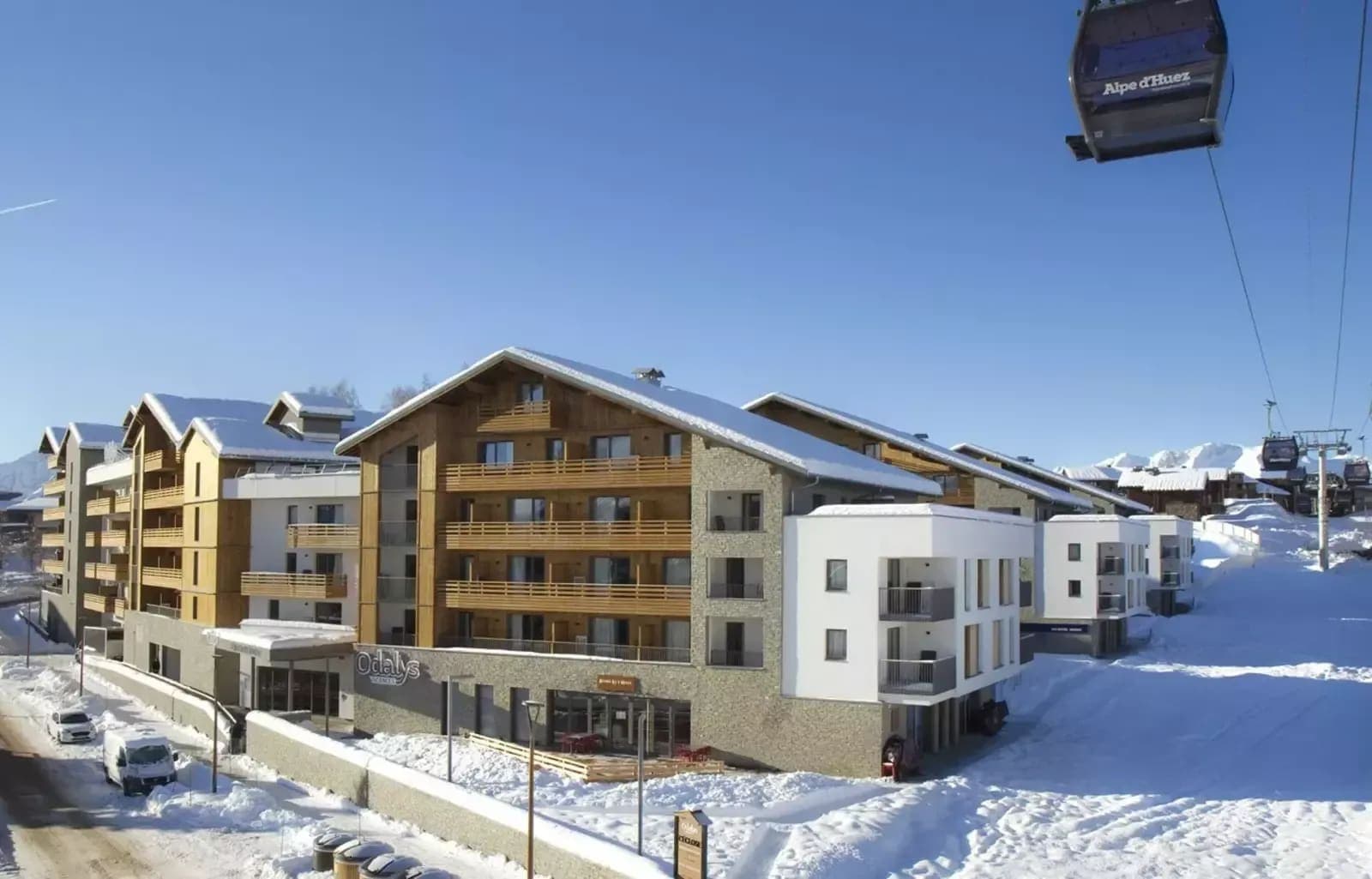 Ski resort building with private balconies located adjacent to Alpe d'Huez gondola